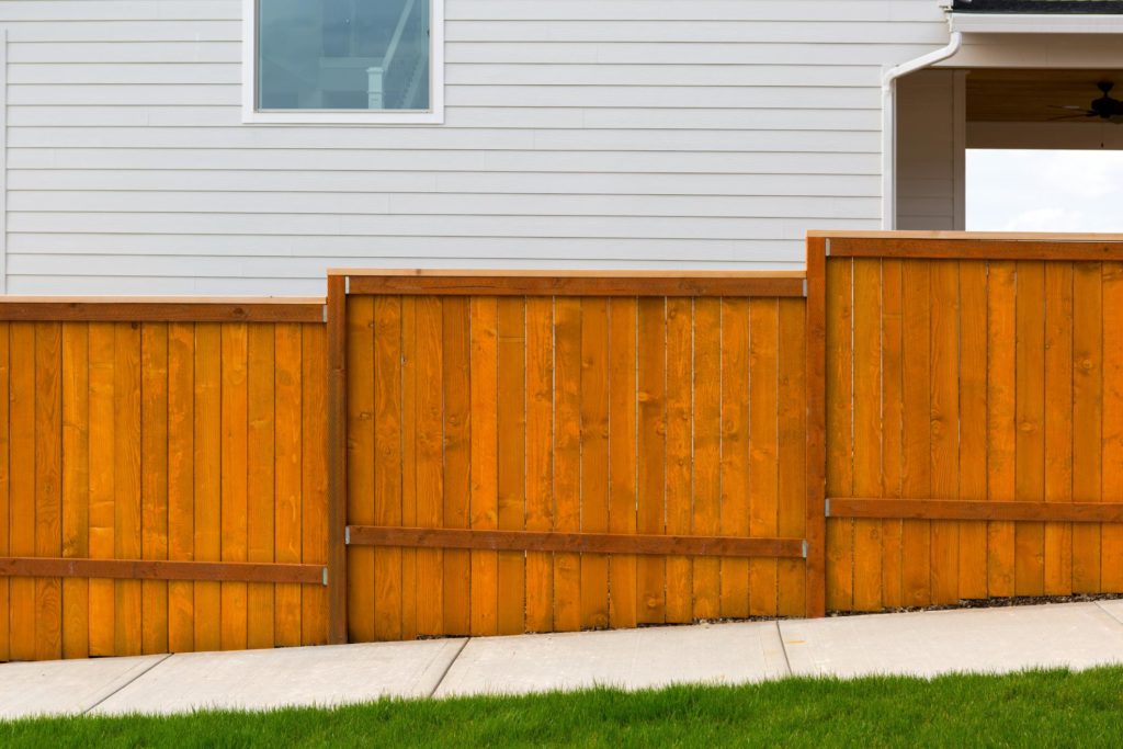 a house with wood cedar fence