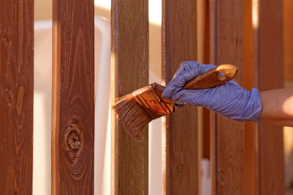 unrecognized person painting the fence